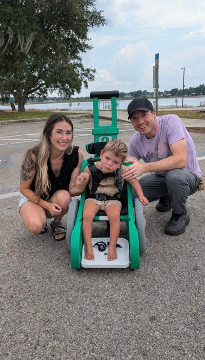 Family is shown with green Toddler Mobility Trainer